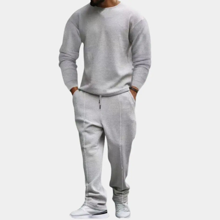 https://cdn.shopify.com/s/files/1/0879/0949/9227/files/Grijs_Ellroy_Luxe_Heren_Tweedelige_Set_Tijdloos_comfort_voor_de_moderne_man_T-E.png